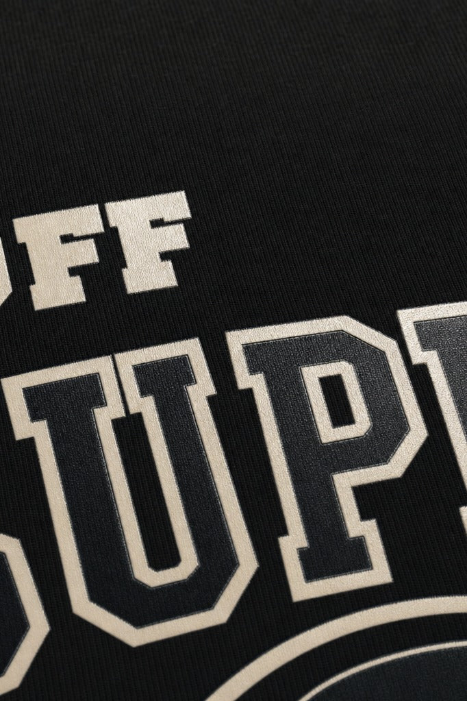 Close-up fabric detail - Off supply Varsity text Black T-shirt